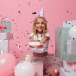 portrait-of-a-joyful-little-girl-in-a-birthday-hat