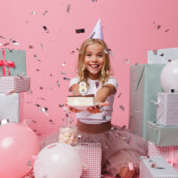 portrait-of-a-joyful-little-girl-in-a-birthday-hat